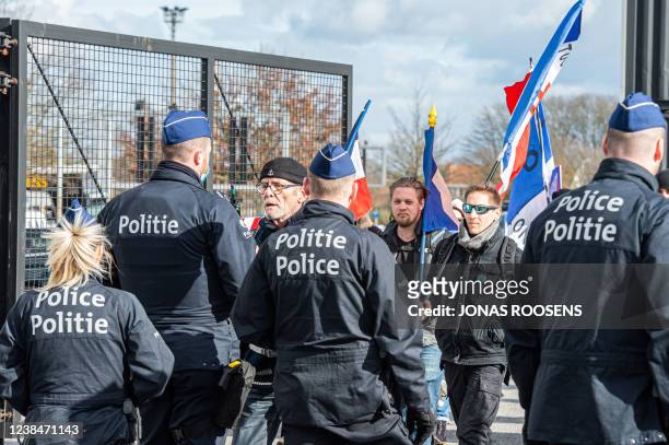 Protesters have a conversation with police on Parking C of the Heizel - Heysel expo area, at a protest action against corona-measures where people...