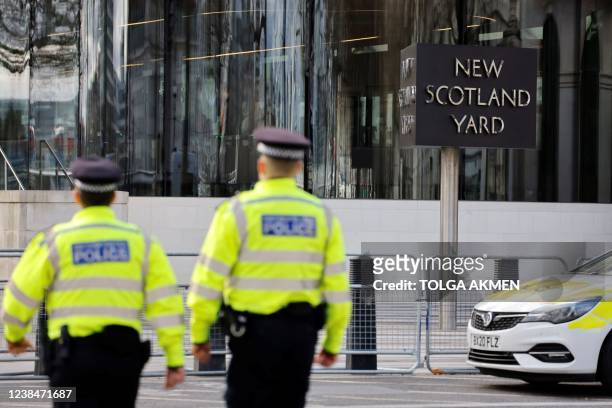 Britain's police officers patrol in front of Scotland Yard, central London, on February 14, 2022.