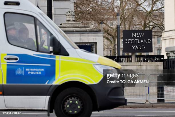 British police vehicle is parked in front of Scotland Yard, central London, on February 14, 2022.