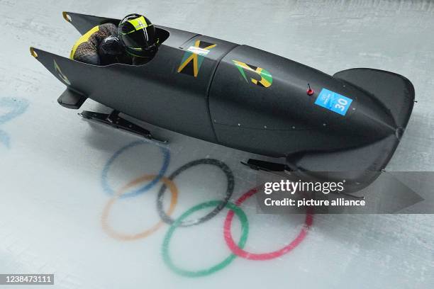 February 2022, China, Yanqing: Olympics, bobsleigh, two-man bobsleigh, men, 1st run at the National Sliding Centre, bobsleigh pilot Shanwayne...