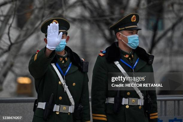 Chinese paramilitary policemen keep watch at the promenade on the Bund along the Huangpu River in Shanghai on February 14, 2022.