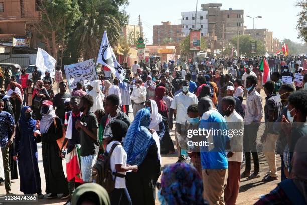 Sudanese protesters march during a demonstration calling for civilian rule and denouncing the military administration, in the capital Khartoum's twin...