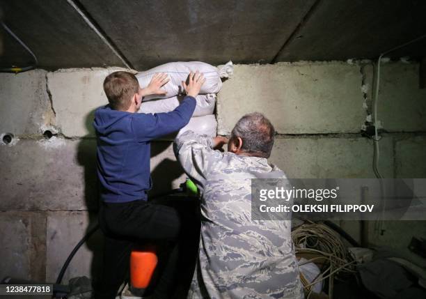 Ukrainian teenager and a Pentecostal pastor reinforce basements in a centre for children which are use to dig trenches for soldiers serving on their...