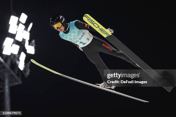 Yixin Lyu of China in action competes during the men´s team ski jumping from the large hill during the Beijing 2022 Winter Olympics at National Ski...