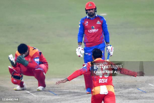 Islamabad United's Asif Ali celebrates after taking the wicket of Karachi Kings' Mohammad Nabi during the Pakistan Super League Twenty20 cricket...