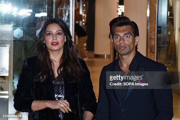 Bollywood actor Karan Singh Grover reacts to the camera as he pose for a photo along with his actress wife Bipasha Basu in Mumbai. The couple was...