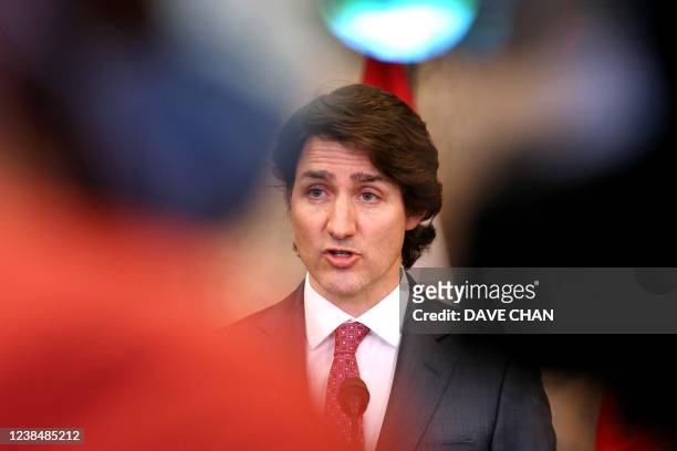Canada's Prime Minister Justin Trudeau comments on the on going truckers mandate protest during a news conference on Parliament Hill in Ottawa,...