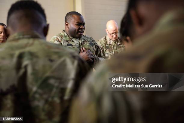 Soldiers with the 82nd Airborne division pray together before boarding planes to deploy to Poland on February 14, 2022 at Fort Bragg, Fayetteville,...