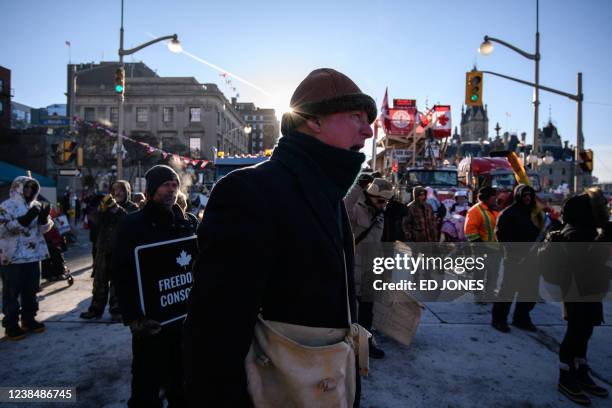 Demonstrators cheers during a protest by truck drivers over pandemic health rules and the Trudeau government, outside the parliament of Canada in...