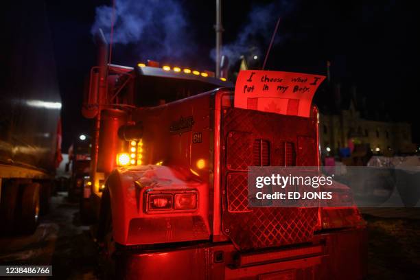 Slogan is displayed on the frot of a truck blocking a road during a protest by truck drivers over pandemic health rules and the Trudeau government,...