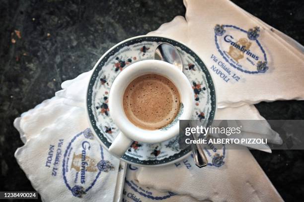 Picture taken on February 13, 2022 shows a cup of espresso coffee at the historic Gran Caffe Gambrinus in Naples, Italy. A shot of dark, velvety...