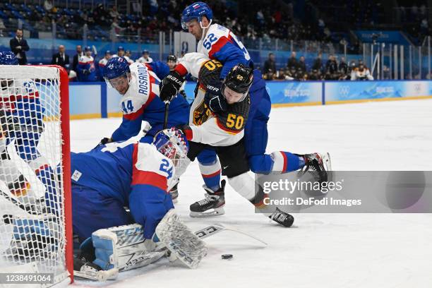 Goalkeeper Patrik Rybar of Slovakia, Mislav Rosandic of Slovakia, Martin Marincin of Slovakia and Patrick Hager of Germany battle for the puck at the...