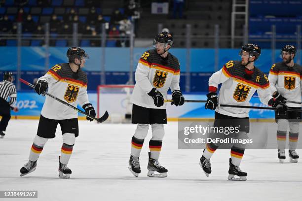 Dominik Kahun of Germany, Marcel Noebels of Germany and Patrick Hager of Germany discusses at the men's ice hockey playoff qualifications match...