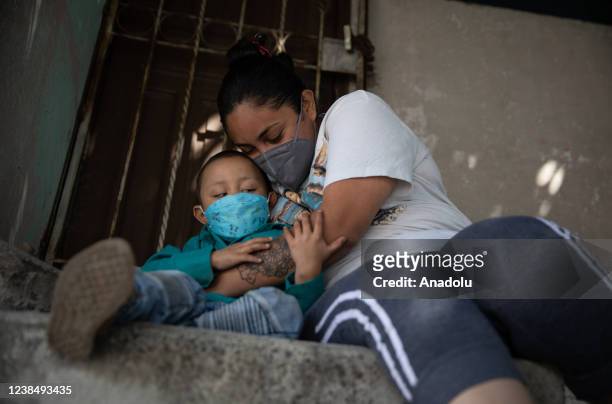 Years-old Iker Andres Nolasco, a child diagnosed with acute lymphoblastic leukemia in 2021, is hugged by his mother, Ariana Gallardo at home of his...