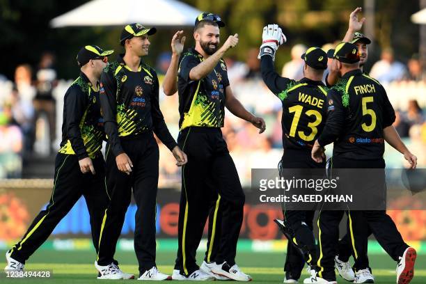 Australia's Kane Richardson celebrates with teammates after taking the wicket of Sri Lanka's Danushka Gunathilaka during the third T20 international...