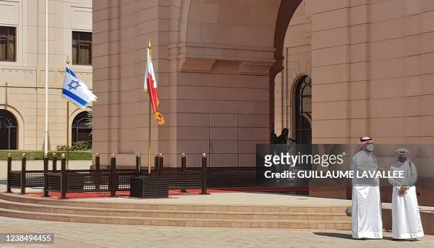 The flags of Israel and Bahrain are seen outside the al-Qudaibiya palace in the Bahraini capital Manama, on February 15, 2022. - Bennett arrived in...