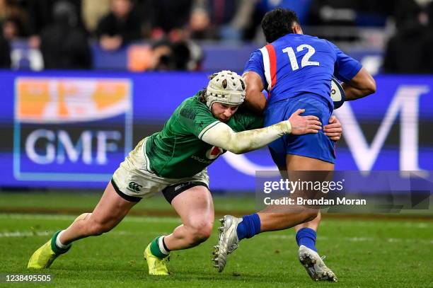 Paris , France - 12 February 2022; Mack Hansen of Ireland tackles Yoram Moefana of France during the Guinness Six Nations Rugby Championship match...