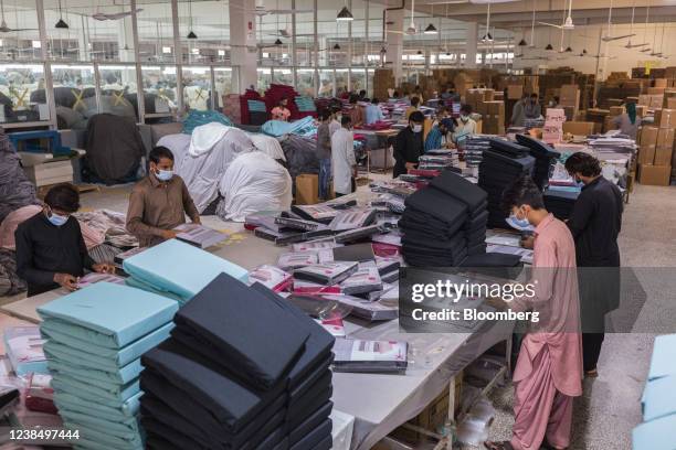 Workers arrange pieces of fabric inside the knitting division at a Gadoon Textile Mills Ltd. Factory in Karachi, Pakistan, on Friday, Feb. 11, 2022....