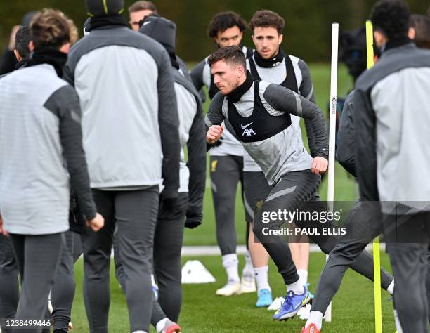 Liverpool's Scottish defender Andrew Robertson and Liverpool's Portuguese striker Diogo Jota attend a training session at their training ground in...