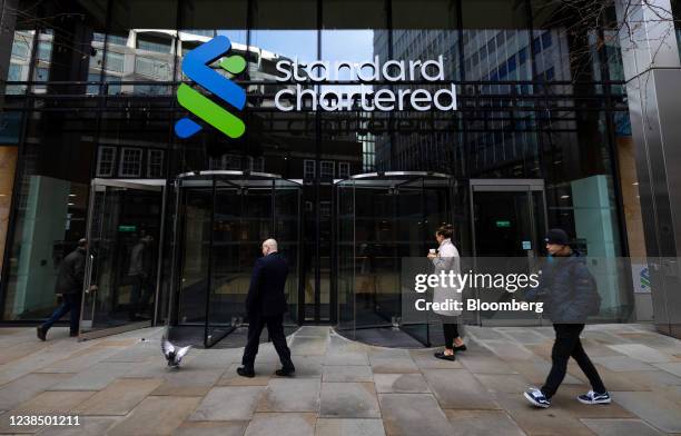 Pedestrians pass the headquarters of Standard Chartered Plc in London, U.K., on Monday, Feb. 14, 2022. European banks have largely thrived in the...