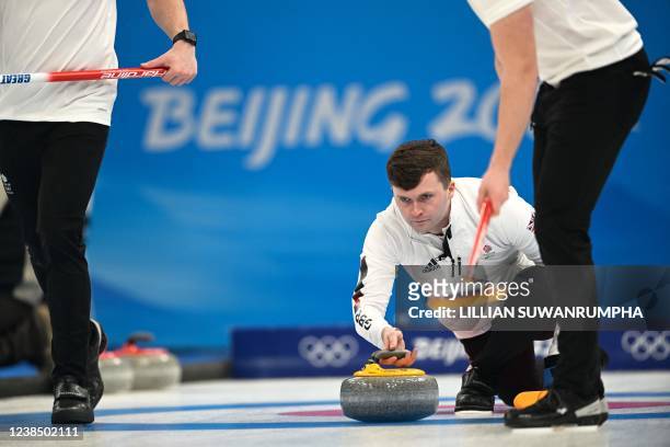 Great Britain's Bruce Mouat curls the stone during the men's round robin session 10 game of the Beijing 2022 Winter Olympic Games curling competition...