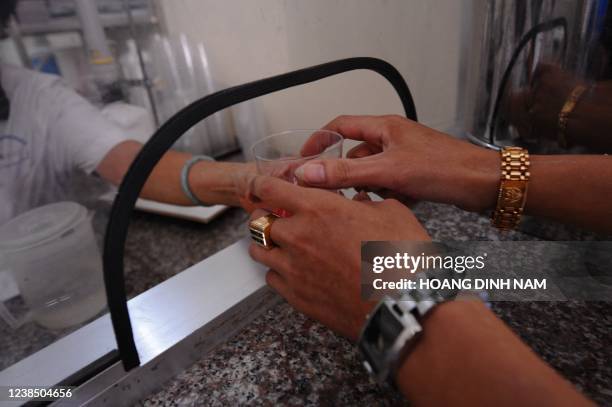 In a picture taken on August 12, 2010 a drug addict receives his daily dose of methadone at the Drug Treatment by Methadone Center in the northern...
