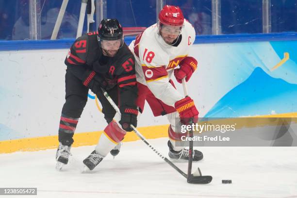 Jinguang Ye of Team China challenge during the Mens Ice Hockey Qualification Playoff match between Team China and Team Canada on Day 11 of the...