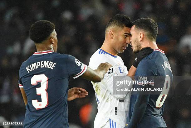 Real Madrid's Brazilian midfielder Casemiro and Paris Saint-Germain's Argentinian midfielder Leandro Paredes clash next to Paris Saint-Germain's...