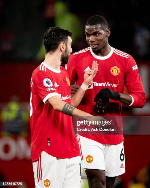 Bruno Fernandes of Manchester United celebrates with team-mate Paul Pogba at the end of the Premier League match between Manchester United and...