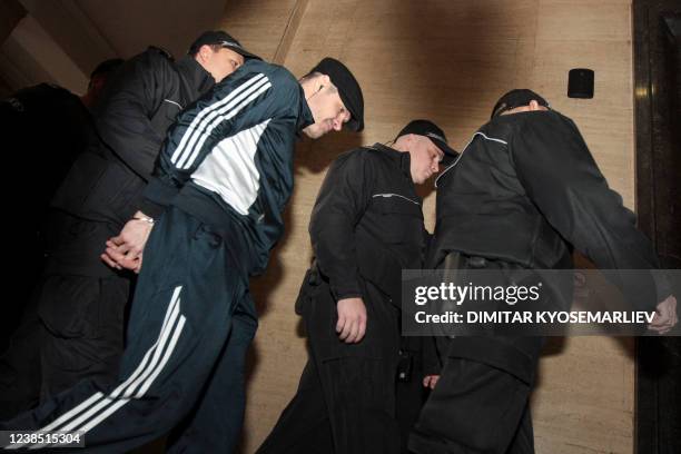 This picture taken on December 16, 2013 shows former wrestler Evelin Banev walking escorted by policemen at the court in Sofia. - Last week hearings...