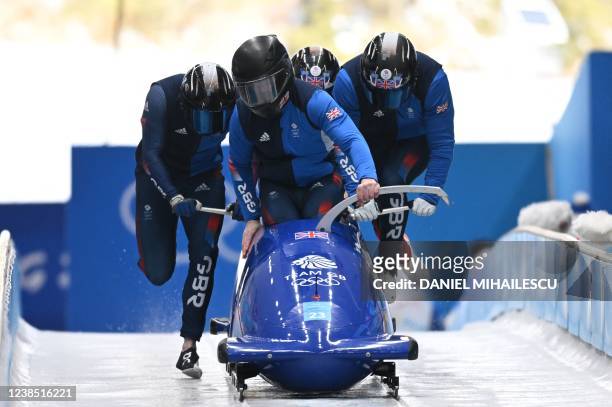 Britain's Brad Hall and his team take part in the 4-man bobsleigh training at the Yanqing National Sliding Centre during the Beijing 2022 Winter...