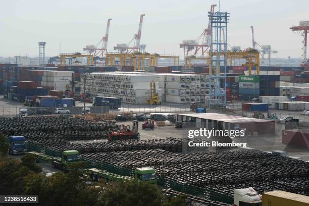 Containers in front of gantry cranes at a shipping terminal in Yokohama, Japan, on Monday, Feb. 14, 2022. Japan is scheduled to release trade balance...