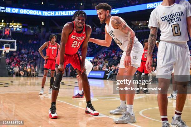 State forward Ebenezer Dowuona shares a moment with Georgia Tech center Rodney Howard during the ACC college basketball game between the North...