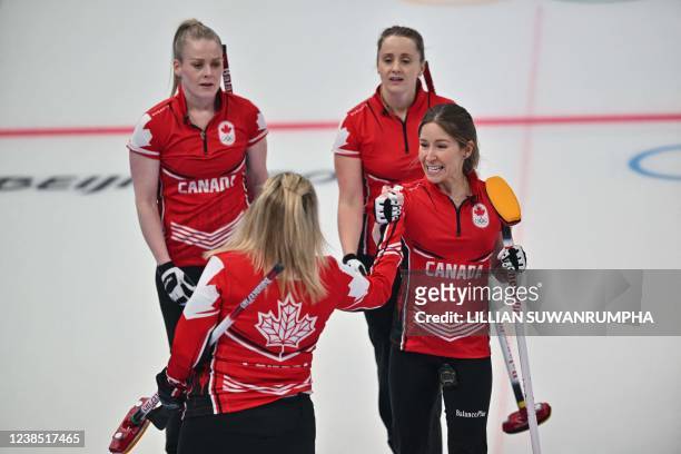 Canadas Jennifer Jones , Dawn McEwen , Jocelyn Peterman and Kaitlyn Lawes celebrate during the womens round robin session 10 game of the Beijing 2022...
