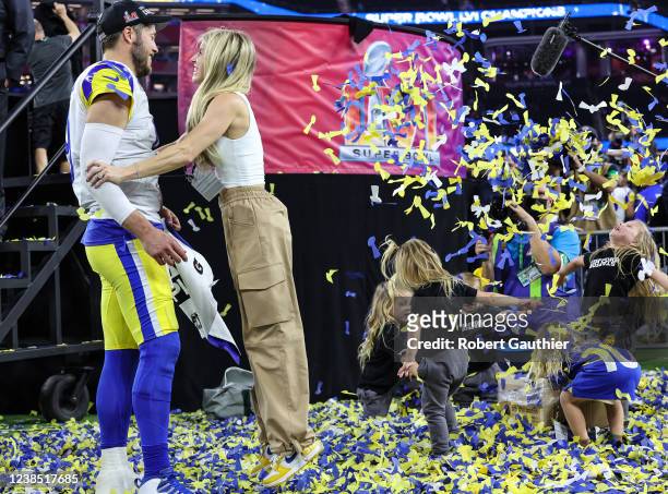 Inglewood, CA, Sunday, February 13, 2022 - Rams quarterback Matthew Stafford is embraced by his wife, Kelly as their children frolic in confetti...