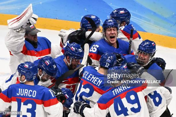 Slovakia's players celebrate victory during the men's play-off quarterfinal match of the Beijing 2022 Winter Olympic Games ice hockey competition...