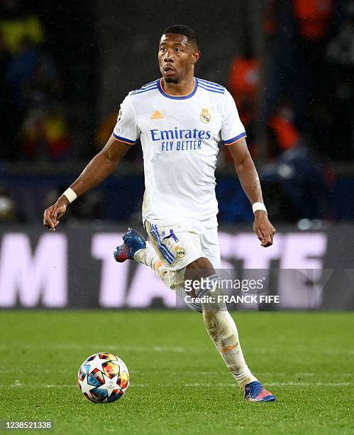 Real Madrid's Austrian defender David Alaba runs with the ball during the UEFA Champions League round of 16 first leg football match between Paris...