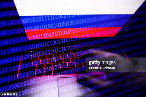 Russian flag displayed on a laptop screen and binary code code displayed on a screen are seen in this multiple exposure illustration photo taken in...