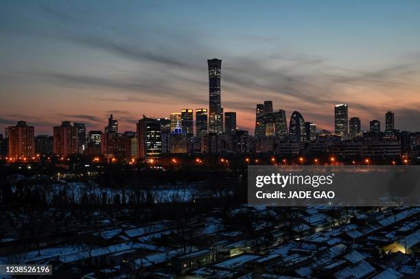 This general view shows the skyline over the central business district at sunset in Beijing on February 16, 2022.