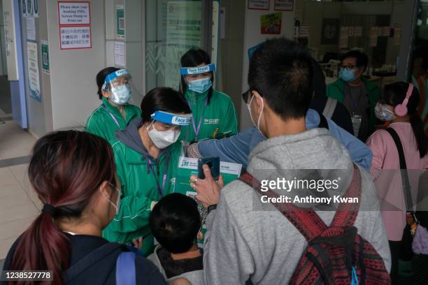 Children and parents line up to receive BioNTech COVID-19 vaccine at Hong Kong Children's Hospital on February 16, 2022 in Hong Kong, China. Hong...