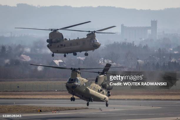 Air Force CH-47 Chinook helicopters are seen landing at the airport in Jasionka near Rzeszow, south eastern Poland, February 16, 2022. - Dozens of US...