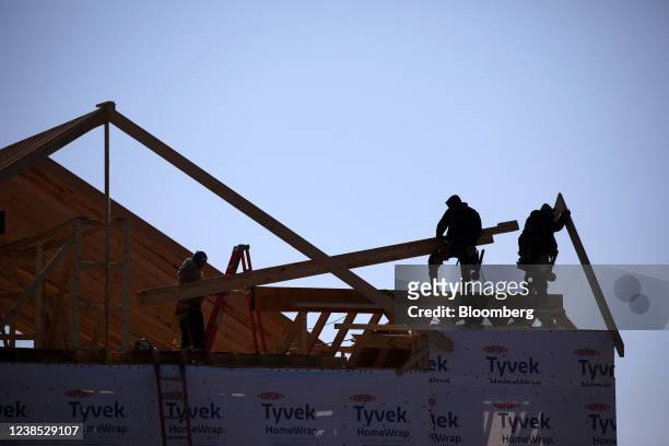 Contractors build the framing of a roof on a house under construction at the Norton Commons subdivision in Louisville, Kentucky, U.S., on Tuesday,...