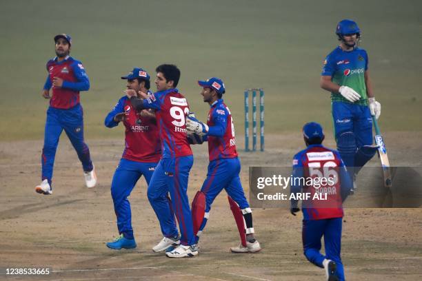 Karachi Kings' players celebrate after the dismissal of Multan Sultans' Tim David during the Pakistan Super League Twenty20 cricket match between...