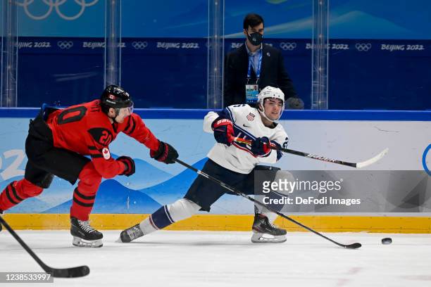 Alex Grant of Canada and Sean Farrell of USA battle for the puck at the men's ice hockey group A preliminary round match between Canada and USA...