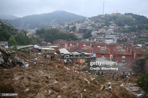 Residents and rescue workers clear debris after heavy rains caused landslides in Petropolis, Rio de Janeiro state, Brazil, on Wednesday, Feb. 16,...