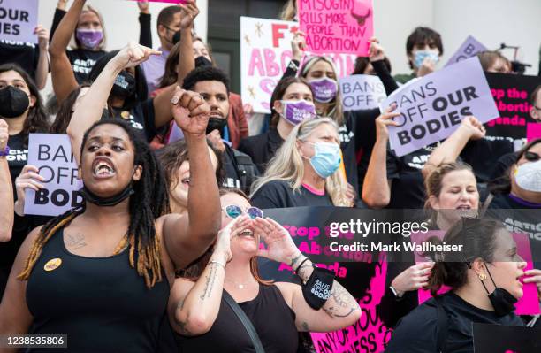 Kate Dandy-Samitz, center, leads protest chants at the Florida Capitol as advocates for bodily autonomy protest a bill before the Florida legislature...