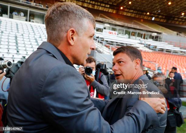 Sebastian Battaglia head coach of Boca Juniors greets Martin Palermo head coach of Aldosivi before a match between Aldosivi and Boca Juniors as part...