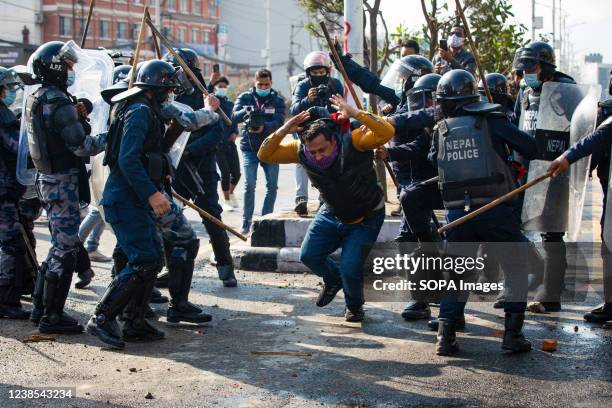 Nepali riot policemen beat protesters during a protest in Kathmandu. Different political parties youth wings clash with Nepal police outside Federal...