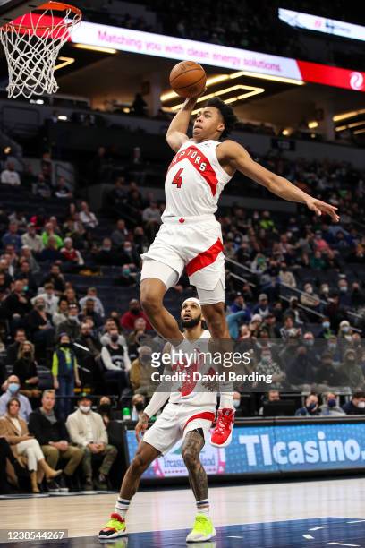 Scottie Barnes of the Toronto Raptors dunks the ball while Gary Trent Jr. #33 looks on in the first quarter of the game against the Minnesota...