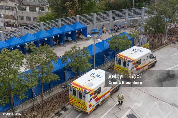 Ambulances outside a temporary isolation facility for patients displaying Covid-19 symptoms at the Caritas Medical Center hospital in Hong Kong,...